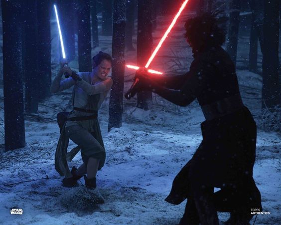 An screenshot of the movie Star Wars: The Force Awakens as two people fight with red and blue lightsabers in a dark, snowy forest